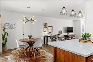 a kitchen and living room with a table and chairs at Stylish 3BR 2BA House Minutes from PCB - Book now in Panama City