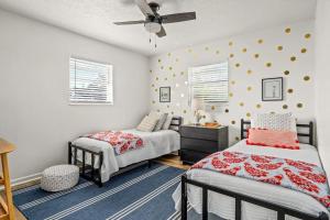 a bedroom with two beds and a ceiling fan at Stylish 3BR 2BA House Minutes from PCB - Book now in Panama City