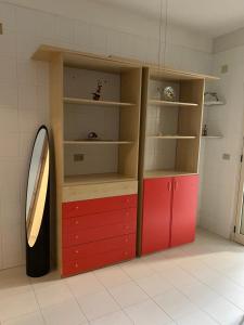 a room with red cabinets and a mirror at Sea apartment, Gallipoli baia verde in Baia Verde +1 photo