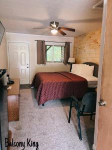 a bedroom with a bed and a ceiling fan at Stony Creek Motel in Maggie Valley
