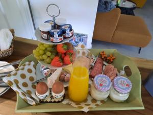 a tray of breakfast food with a drink and fruit at Domstate in Ee +9 photos