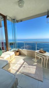 a balcony with a table and a view of the ocean at My White House in Trabzon