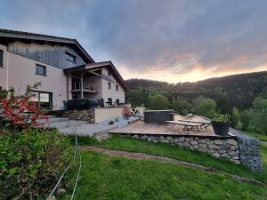 a view of a house with a wooden deck at Chalet Terejo & spa in Ventron