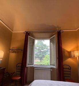 Schlafzimmer mit einem großen Fenster mit roten Vorhängen in der Unterkunft The 1905 house Near Leaning Tower in Pisa