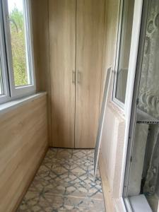 a room with a cabinet and a window at Апартамент Плаза in Shymkent