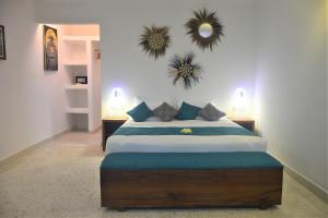 1 dormitorio con cama y espejo en la pared en Blue Palm Zanzibar, en Bwejuu
