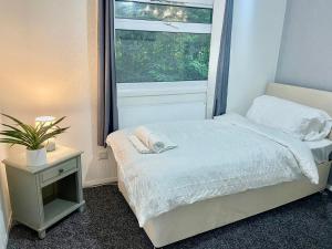 een kleine slaapkamer met een bed en een raam bij Whittams Hot-tub Chalet Retreat in Heysham