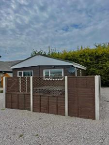 a wooden fence in front of a house at Whittams Hot-tub Chalet Retreat in Heysham