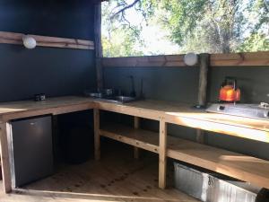 a kitchen with a counter with a sink and a window at Phazama Farm in Maun