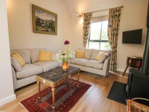 a living room with a couch and a table at The Mission Room in Malpas