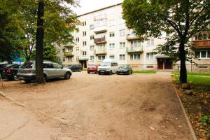 a parking lot with cars parked in front of a building at Smolensko st 13 Vilnius Students Home LT in Vilnius