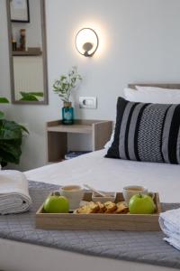 a tray with apples and cookies on a bed at Your Destination in Lixouri