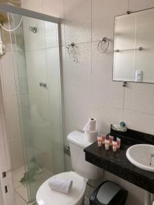 a bathroom with a shower and a toilet and a sink at Pousada Las Palmas in Guarujá +123 photos