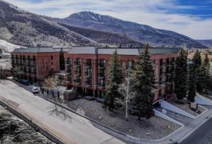 an aerial view of a building with mountains in the background at Luxe Park City Mountain Resort Studio in Park City