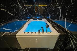 a bath tub with two faucets in a bathroom at Garden Room Otel in Istanbul