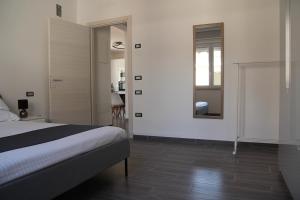 um quarto com uma cama e um espelho na parede em Dimora Due Galli em Ponti Sul Mincio