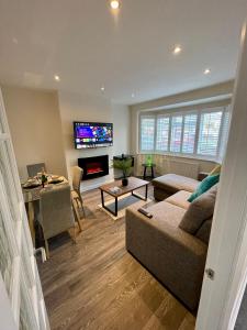 a living room with a couch and a tv at Paul Properties in Ruislip