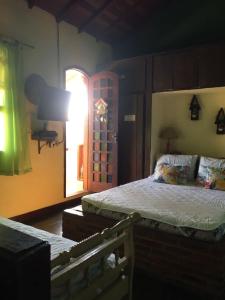 1 dormitorio con 2 camas y ventana en Saquarema hospedagem en Saquarema