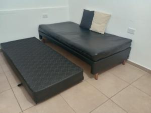 a black couch with a pillow on top of it at CENTENO CASI 9 DE JULIO in Santa Rosa +7 photos