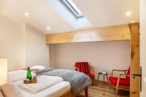 a attic bedroom with a bed and a skylight at Xaver in Rottenbuch