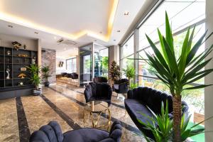 a lobby with black chairs and plants at Garden Room Suit Hotel in Istanbul +122 photos