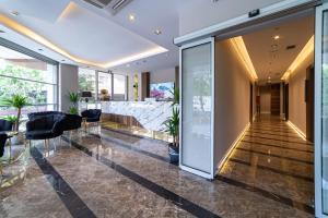 a lobby of a building with glass doors and plants at Garden Room Otel in Istanbul +117 photos