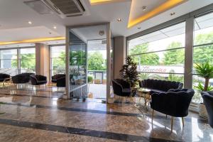 a lobby with chairs and tables and windows at Garden Room Suit Hotel in Istanbul