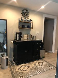 a room with a black cabinet and a clock on the wall at 2 Bd/3 Ba, Luxury Ski-in Ski Out Condo - Sleeps 10 in Park City