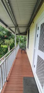 a porch with a bench on a house at Lynn's Getaway Apartments in Apia