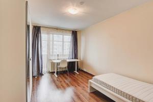 a bedroom with a bed and a table and a window at Žirmūnų st 115 Vilnius Students Home LT in Vilnius