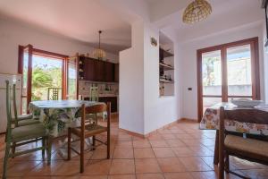 Villa Emy في مسينة: مطبخ وغرفة طعام مع طاولة وكراسي
