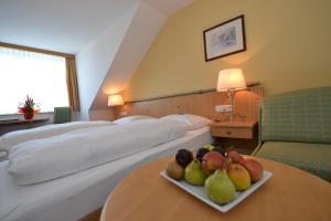 a hotel room with a plate of fruit on a table at Hotel Kohlpeter in Salzburg