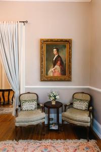 a room with two chairs and a painting on the wall at Stanley House Inn in Marietta