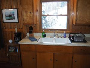 a kitchen with a sink and a window at The Crystalaire Cabin - Charming And Relaxing! in Frankfort