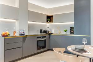 a kitchen with a table and a dining room at ShySuite 1BED in London
