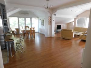 a living room with a hard wood floor and a living room at Omeros in Gevgelija