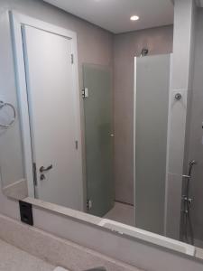 a large mirror in a bathroom with a shower at Hotel Le Canard Lages in Lages