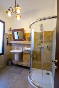 a bathroom with a shower and a sink at Pensiunea Edelweiss, Putna in Putna