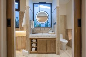 a bathroom with a sink and a mirror and a toilet at Malecón 1680 in La Paz