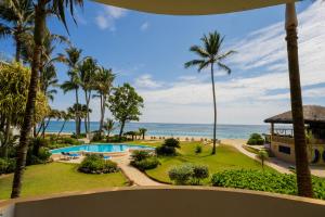 a view of the beach from the balcony of a resort at Agualina Kite Hotel Oceanfront Apartments in Cabarete