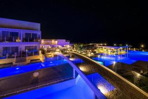 een zwembad 's nachts met blauwe lichten bij Insula Alba Resort & Spa (Adults Only) in Chersonissos