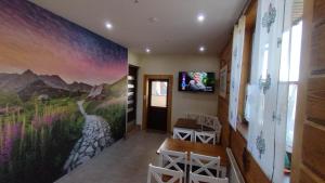 a hallway with a painting on the wall at VILLA JAGODOVO Biały Dunajec in Biały Dunajec
