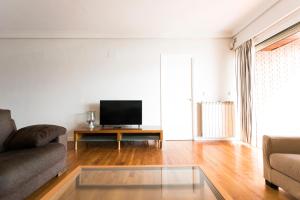 a living room with a couch and a flat screen tv at Hondarribia by Basquelidays in Hondarribia