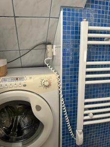 a washing machine in a blue tiled bathroom at Old Town Lucky Star Split in Split
