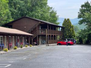 a red car parked in front of a building at Stony Creek Motel in Maggie Valley