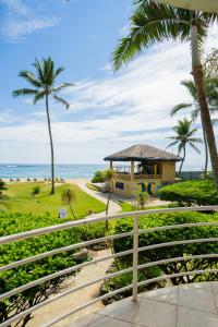 a view of the beach from the balcony of a resort at Agualina Kite Hotel Oceanfront Apartments in Cabarete