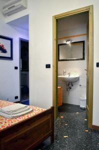 a bathroom with a bed and a sink and a mirror at Bed And Breakfast Arcobaleno in Bologna