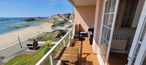 a balcony with a view of the beach at Palmeira in Ribeira +1 photo