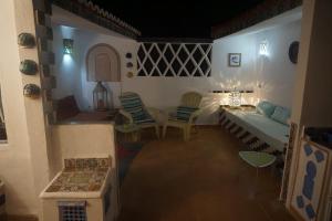 a living room with a couch and a stove at Dar Anneke in Chefchaouen