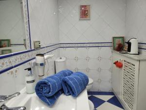 a bathroom with a sink and a blue towel at Privada Confort Granada in Granada